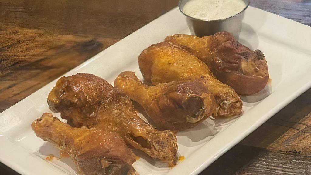 Buffalo Drummies · Wing-Sized chicken drumsticks tossed with house buffalo sauce served with your choice of ranch or bleu cheese