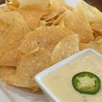 Pepper Jack Queso · Corn tortilla chips and pepper jack queso
