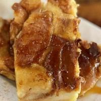 Bourbon Bread · Homemade bread pudding topped with Bourbon Glaze, cinnamon sugar and a scoop of vanilla ice ...