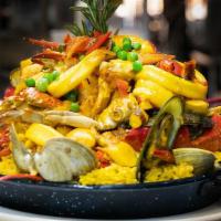 Paella Casa Del Mar (New) · House seafood paella with lobster tail, shrimp, mussels, clams, calamari and crabs over yell...