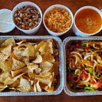 Fajitas Family Pack · 1 medium fajitas tray, 1 32 oz side of beans, 1 32 oz side of rice, 1 medium chips tray and ...
