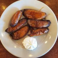 Platano Macho · Deep fried plantain topped with whipped cream and condensed milk