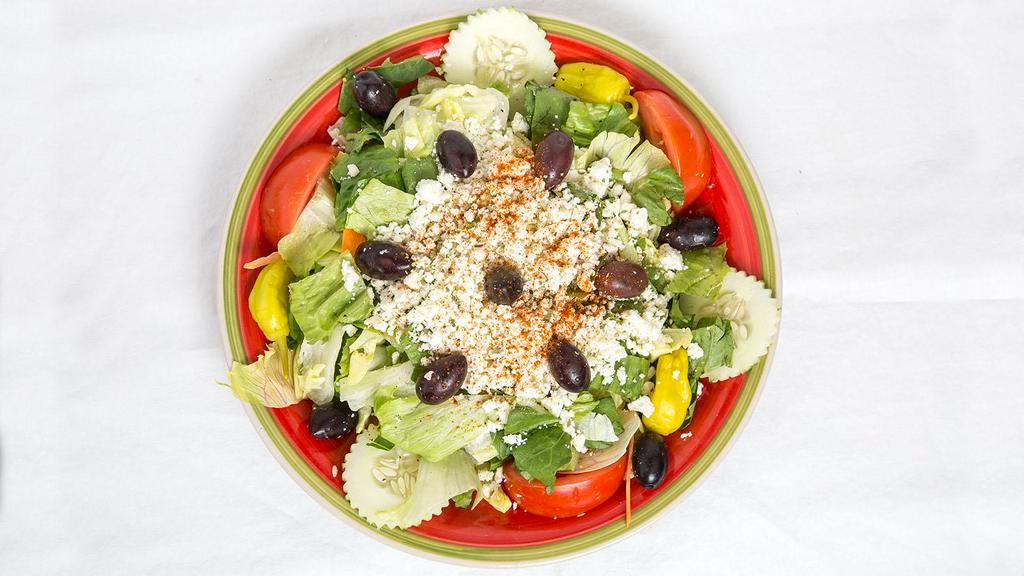 Greek Salad · Iceberg and romaine lettuce tomato,cucumber pepperoncini ,kalamata olives topped with feta cheese and served with Greek salad vinaigrette.