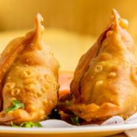 Vegetable Samosa (2) · Two deep-fried triangular-shaped pastries stuffed with spiced potatoes and green peas.