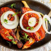 Tandoori Chicken · Half chicken marinated overnight in yogurt, spices, and herbs; Roasted in a clay oven over c...