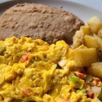Huevos A La Mexicana · Scrambled eggs with tomatoes, onions and peppers.