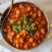 Chana Masala · Garbanzo beans cooked with onions and tomato with fresh ground spices.