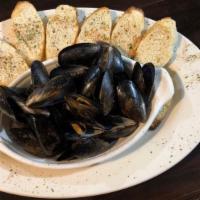 Steamed Mussels Or Clams · 1 lb steamed to perfection and served with garlic butter and pita bread.