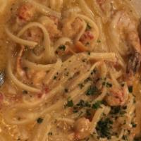 Creole Pasta · Linguine Pasta mixed in a Creole Cream Sauce, with Red Onions and Sweet Peppers. Topped with...
