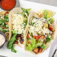 Street Tacos · Corn tortilla topped with choice of meat, cilantro, and onions. Lime on the side. Single Tac...