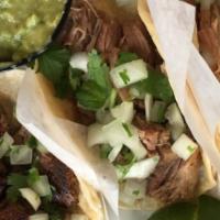 Al Pastor Tacos · Three marinated pork tacos with pineapple on soft corn tortilla, topped with cilantro and on...