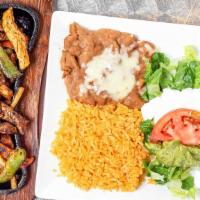 Fajitas · Choice of steak or Chicken grilled with onions, tomatoes, and bell peppers. Served with spin...