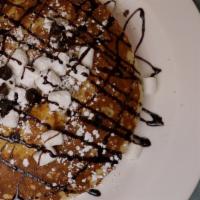 S'Mores Pancakes · Chocolate Chips, Mini Marshmallows, Graham Cracker Crumbs & Chocolate Sauce.