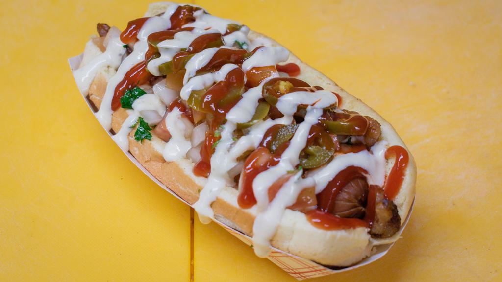 Mexican Perro · A Mexican twist to our Famous Perro: a hot dog with a pork frank, mustard, mayo, ketchup, crumbled queso fresco, crushed potato chips, hot sauce, salsa rosada, bacon, grilled onions, cilantro and tomatoes, garnished with a hard boiled quail egg.