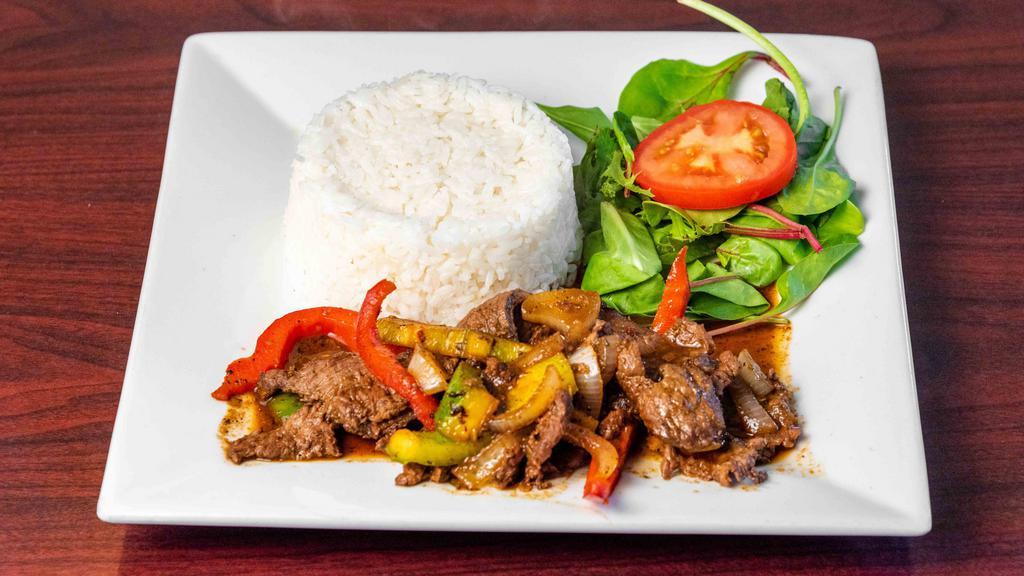 Bistec Encebollado · Deliciously seasoned beef steak and onions served with your choice of a side.