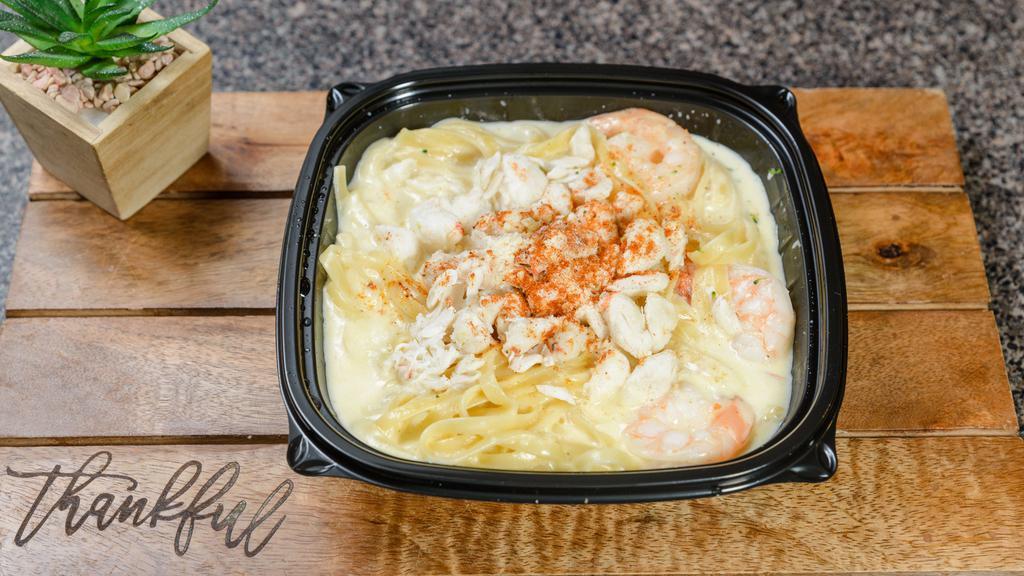 Shrimp & Crab Alfredo · Crab meat and shrimp served with alfredo sauce over fettuccine noodles.