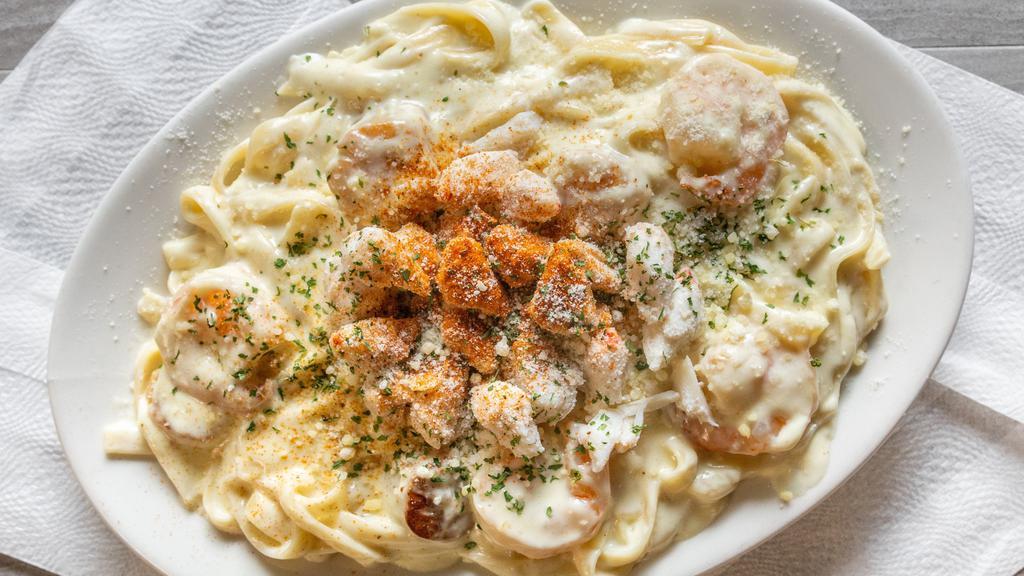 Seafood Alfredo · Crab meat, shrimp and scallops served with Alfredo sauce over fettuccine noodles.