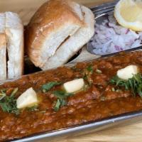 Tava Pav Bhaji · Mashed Vegetables, dollop of butter, diced red onions, cilantro and a squeeze of lime.
