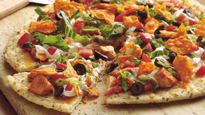 Taco Pizza · Bean spread, ground beef, mix cheddar cheese, pico de gallo, black olives shredded lettuce