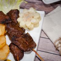 Anticuchos De Caretilla · Two grilled beef hearts skewers, served with two sides, anticuchera sauce.