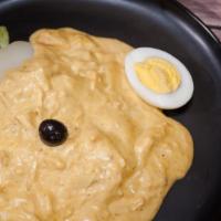 Aji De Gallina · Chicken breast strips served in a creamy Aji amarillo and cheese sauce. Served with potatoes...