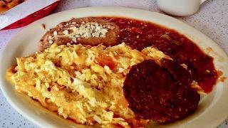 Migas Plate · Three eggs scrambled with fried tortilla chips, onions and tomatoes, topped with melted chee...