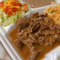 Carne Guisada Plate · served with lettuce, tomatoes, cheese, and a side of rice and beans