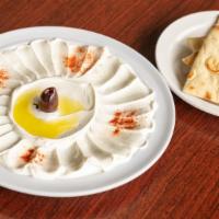 Labneh · Thick and sour yogurt cheese dip garnished with olive oil, paprika and black olives. Served ...