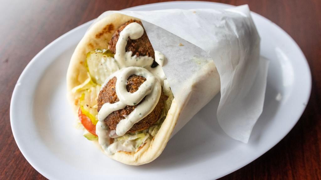 Falafel Gyro Wrap · Deep fried balls with tahini sauce. Served with lettuce, tomatoes, onions and pickles.