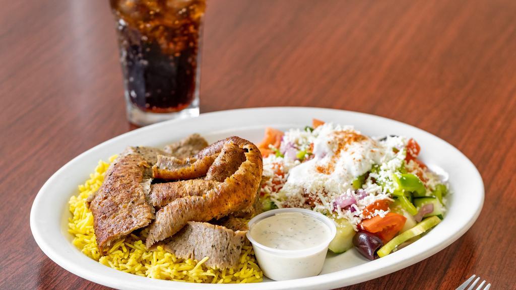 Lamb Gyro Plate · Freshly shaved lamb and beef slices served with basmati rice and greek salad.