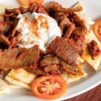 Iskander Plate · Lamb gyro meat mixed with tomato sauce. Served with cut pita and topped with healthy portion...