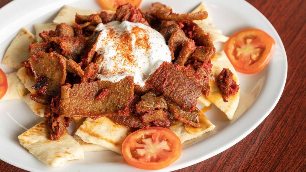 Iskander Plate · Lamb gyro meat mixed with tomato sauce. Served with cut pita and topped with healthy portion of tzatziki.