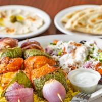Veggie Kabob Plate · Two skewers of freshly grill tomatoes, onions, green peppers, and mushrooms. Served with bas...