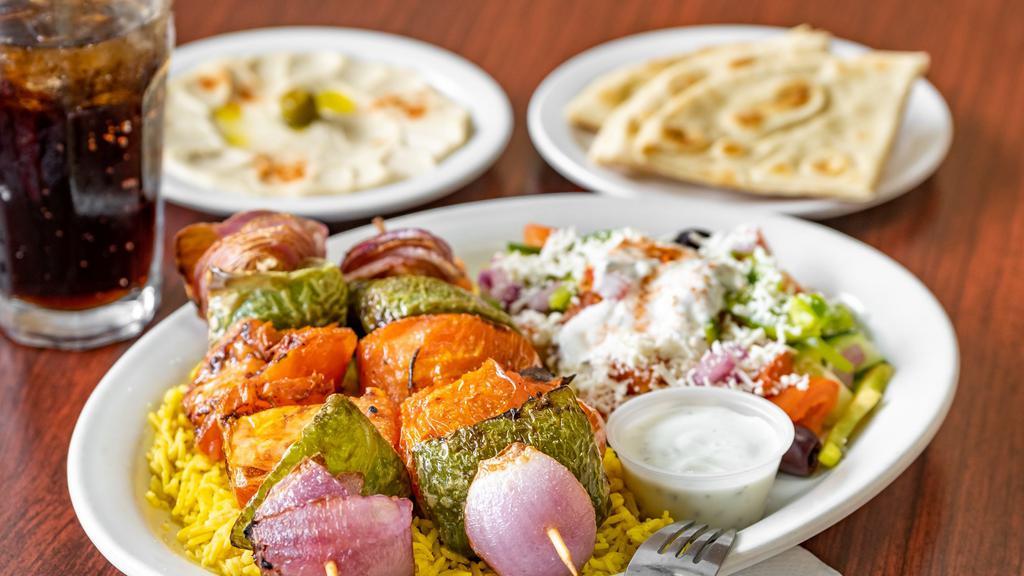 Veggie Kabob Plate · Two skewers of freshly grill tomatoes, onions, green peppers, and mushrooms. Served with basmati rice, greek salad and side of hummus with pita bread.