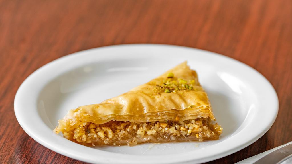 Baklava · Delicate layers of filo pastry filled with walnuts and pistachios moistened with a light sugar syrup.