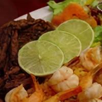 Carne Asada Con Camarones / Grilled Beef With Grilled Shrimp · Con arroz, frijoles, maduroes, ensalada, crema y tortillas. / Served with rice, beans, sweet...