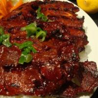 Grilled Pork Chop · Two pork chops served with steamed rice and vegetables.