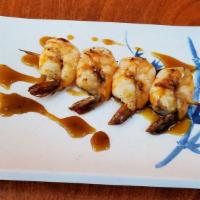 Shrimp Skewer · Four skewered shrimp grilled and seasoned.