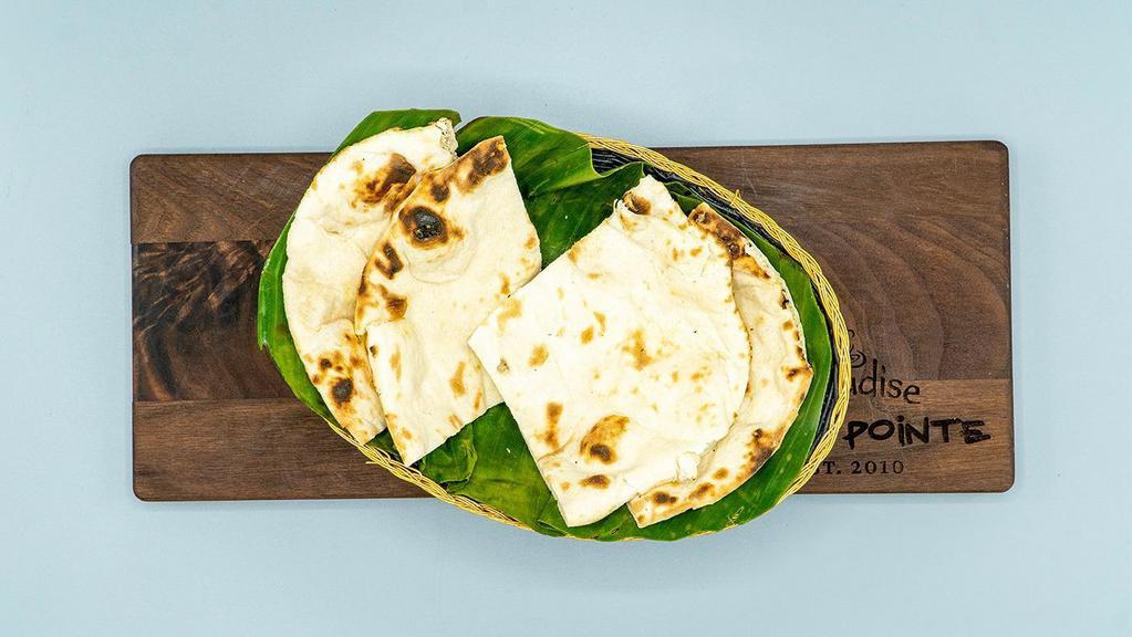 Plain Naan · Delicious and soft leavened white bread resembling a pita bread, baked in tandoor or clay oven.