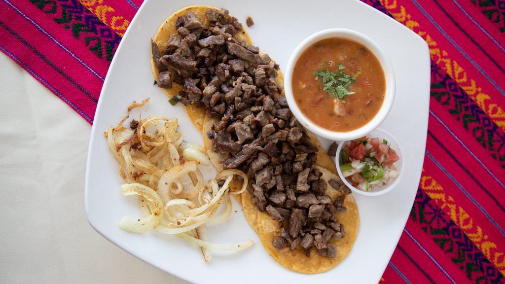 Arrachera Tacos · Grilled arrachera steak, folded in six warm corn tortillas, charro beans, pico de gallo and grilled onions.