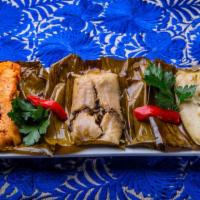 Tamales Oaxaqueños · Three banana leaf-wrapped tamales - pork, chicken and portobello with cuitlacoche.