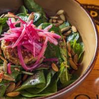 Spinach & Goat Cheese Salad · Baby spinach, caramelized red onions and warm goat cheese encrusted with toasted pumpkin see...