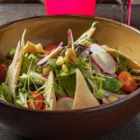 Ensalada Mixta · Mixed greens dressed with radishes, tomatoes, red onions, corn kernels and green olives, wit...