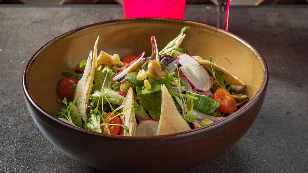 Ensalada Mixta · Mixed greens dressed with radishes, tomatoes, red onions, corn kernels and green olives, with our house vinaigrette and garnished with flour tortilla tostadas.