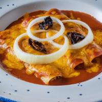 Enchiladas De Tex-Mex · Two chicken, cheese or ground beef picadillo enchiladas, topped with Texas gravy melted ched...