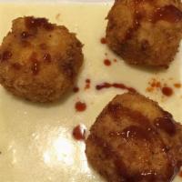 Mac & Cheese Balls · Fried macaroni and cheese mixed with pork ribs served with white cheddar cheese sauce and sp...