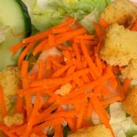 Side Green Salad · Iceberg and romaine lettuce, cucumbers, carrots, tomato and cornbread croutons. Served with ...