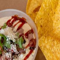 Brisket Queso · You guest it! Brisket, Cheese, Cilantro, Bbq Sauce, Cotija Cheese with house made tortilla c...