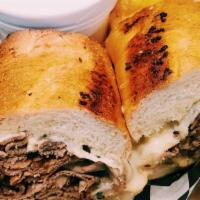 Cheezy Garlic French Dip · Thinly sliced roast beef, served on toasted garlic French bread & topped with gruyère cheese...