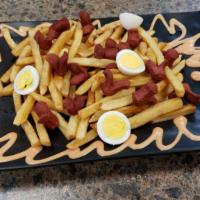Salchipapas · Chopped sausage and french fries.